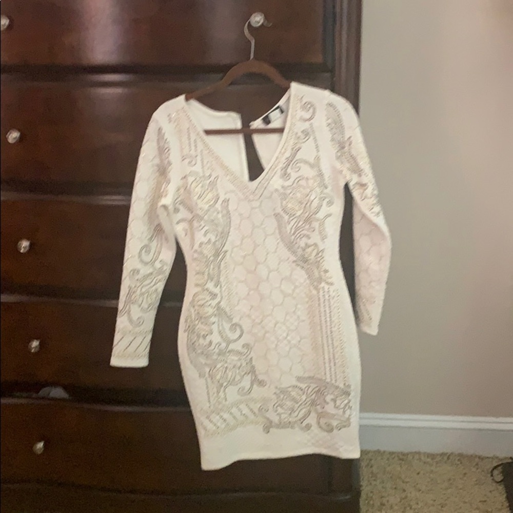 Long sleeved white dress with gold beading